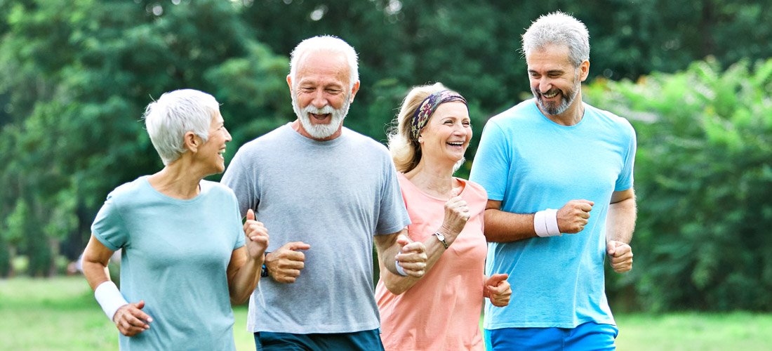 Group of adults running and smiling
