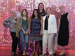 (Left to Right) Inge Plier, SYVCH volunteer; Charles Kirkby, Security Officer Senior, SYVCH; Briana Castro, volunteer; Teresa Soto, Supervisor Patient Access, SYVCH; Jessica Perez, Emergency Technician, SYVCH and SYVCHF Scholarship recipient; Renee Solnit, fashion show dresser and SYVCH volunteer; Carol Anders, SYVCH volunteer; and Holly Thrasher, breast cancer advocate.